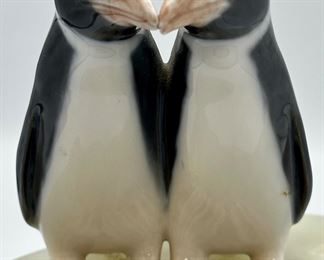 Awe...Two penguins smooching on the side of a slab of onyx.  We believe the penguins are Royal Copenhagen and were attached to this onyx rock specimen.  Clever.
