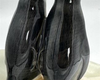 Awe...Two penguins smooching on the side of a slab of onyx.  We believe the penguins are Royal Copenhagen and were attached to this onyx rock specimen.  Clever.