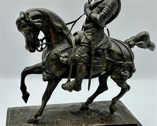 This is a Bronze of Medieval Knight on horseback.  His sword is missing and the Pommel is bent.  Solid Marble Base, very heavy.