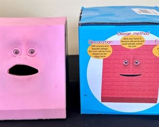 This is a cute electronic Bank that moves mouth when fed a coin