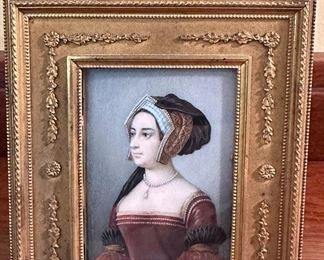 This small painting in a gilt frame appears to be a portrait of Anne Boleyn.  Anne Boleyn c. 1501 or 1507 – 19 May 1536) was Queen of England from 1533 to 1536, as the second wife of King Henry VIII. The circumstances of her marriage and of her execution by beheading for treason and other charges made her a key figure in the political and religious upheaval that marked the start of the English Reformation.