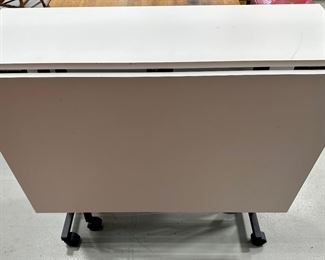 Rio Creations Folding work, sewing, dining table in White partical board on wheels for easy storage and utility. 