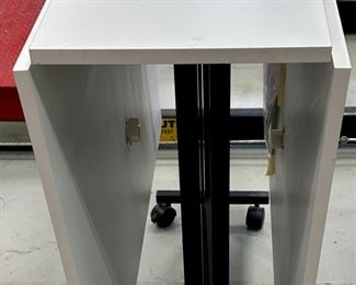 Rio Creations Folding work, sewing, dining table in White partical board on wheels for easy storage and utility.  Pretty handy item for someone who sews, folds laundry, puts together puzzles  or even an extra table when entertaining!  And it folds up!