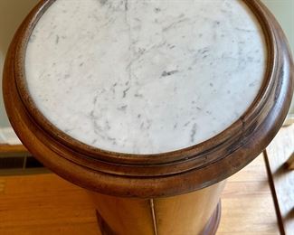 This antique pedestal is solid wood with round marble top and secret door