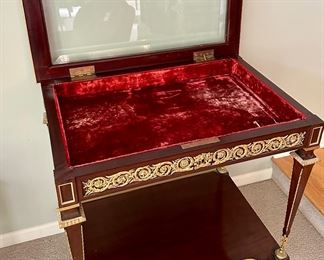 French 19th C. Louis XVI Mahogany Ormolu Display Table with Gold Gilt Detail and Glass Top that opens the case with original Key.  One is selling on 1stDibs for $18,800 to give you an idea on this piece.