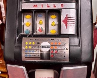 Here's an old antique Five Cent "One Arm Bandit" with a "guaranteed $7.50 payout" by Mills