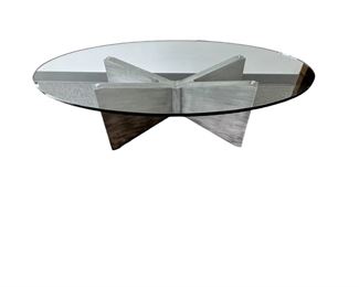 $600 USD      Kravet Oval Glass Top Oval Coffee Table MTF153-13     Description:  Kravet's large oval cocktail/coffee table with substantial cross base in a grey painted wood with 3/4 inch oval glass top. This clean, simple look with sculptural angles beautifully complements other decor while standing out as functional art. Well made table constructed with extraordinary care. Kravet is a century old, family-owned home furnishings business known for its superb craftsmanship and attention to detail.

Dimensions: 60 x 32 x 18.5 H in.  |  3/4 in thick glass top

Condition: New.  The piece was an interior design custom order. The glass top has an internal chip incurred during shipping.  The outside suffers no cracking or chipping and is as smooth to the touch as new glass.  Glass top is easily replaceable.

Location: Local pick up Portland, OR.  Shipping suggestions available upon request.      https://goodbyhello.com/products/kravet-oblong-glass-top-coffee-table-w-x-wood-base-mtf153-13?_po
