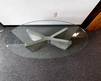$600 USD      Kravet Oval Glass Top Oval Coffee Table MTF153-13     Description:  Kravet's large oval cocktail/coffee table with substantial cross base in a grey painted wood with 3/4 inch oval glass top. This clean, simple look with sculptural angles beautifully complements other decor while standing out as functional art. Well made table constructed with extraordinary care. Kravet is a century old, family-owned home furnishings business known for its superb craftsmanship and attention to detail.

Dimensions: 60 x 32 x 18.5 H in.  |  3/4 in thick glass top

Condition: New.  The piece was an interior design custom order. The glass top has an internal chip incurred during shipping.  The outside suffers no cracking or chipping and is as smooth to the touch as new glass.  Glass top is easily replaceable.

Location: Local pick up Portland, OR.  Shipping suggestions available upon request.      https://goodbyhello.com/products/kravet-oblong-glass-top-coffee-table-w-x-wood-base-mtf153-13?_po