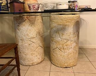 Retro glass top table. Two stone columns with Texas stars on the columns and a star and moon on the top of each. 
