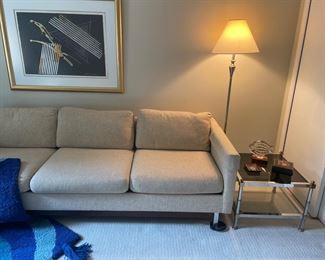 Another view of the MCM couch with chrome legs, side table with chrome and glass, floor lam and framed artwork