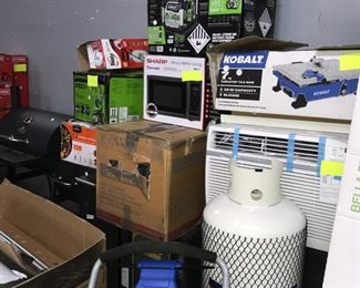 Microwave, propane tank, lawn mower and tile saw table Orlando