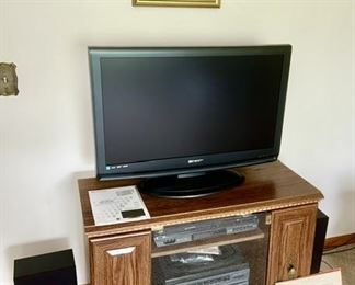 TV/entertainment stand, flatscreen TV, vintage electronics with speakers