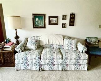 Upholstered sofa, vintage side table, lamps, vintage chair, vintage pictures