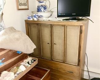 Mid-Century chest of drawers, vintage cedar chest, vintage children's clothing, flatscreen TV, blue and white pitcher and bowl