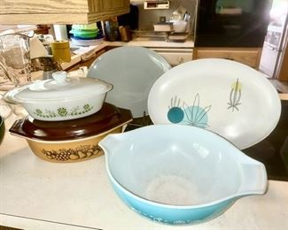 Close-up view of Pyrex Amish princess bowl (SOLD) and Pyrex casseroles, plastic platter & gray ceramic platter