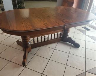 The kitchen table has leaves under the top...