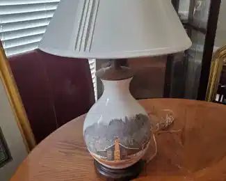 Interesting white lamp accented with a cabin picture