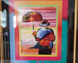   TO BID go to:        https://www.EstateSales.NET/MO/Saint-Louis/63141/marketplace/57517                                                                                                                                             Peter Max ' Umbrella Man on Blends' Iconic Suite 2005, 10" x 8",   Iconic Suite Mixed media with acrylic painting and color lithography on paper.  Hand-signed in acrylic by the artist.  This work of art is one of a series that peter Max did on this theme  (certification papers). Framed 24" x 24"