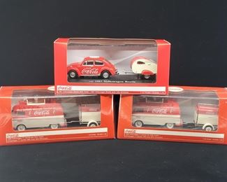 Lot 012-MT: Coca-Cola Die-cast Trio

Features:
•	1 – Coca-Cola 1967 Volkswagen Beetle with trailer
•	2 – Coca-Cola 1960 Volkswagen T1 Kombi Van with trailer

