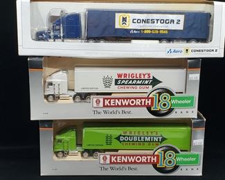 Lot 015-MT: A Die-cast “Semi” Trio #1

Features:
•	Diecast AERO Tractor Cab with Conestoga 2 Trailer, no. 36856
•	Diecast Wrigley’s Spearmint Kenworth 18 Wheeler Metal Bank with Key Operated Lock, #30023
•	Diecast Wrigley’s Doublemint Kenworth 18 Wheeler Metal Bank with Key Operated Lock, #30021

