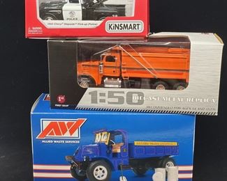 Lot 021-MT: Die-cast Service Vehicle Trio

Features:
•	KiNSMART 1955 “Police” Chevy Stepside Pickup Diecast, KT5330P
•	First Gear Peterbilt 367 Dump Truck Diecast, 50-3357
•	First Gear Allied Waste 1929 Mack AK Dump Truck, 19-3654

