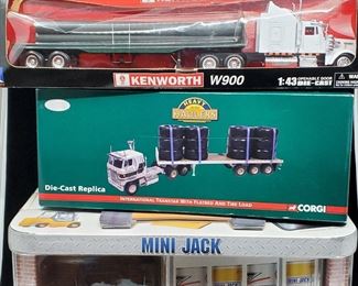 Lot 022-MT: Die-cast “Semi” Duo and a Remote-Controlled Forklift

Features:
•	NewRay Kenworth W900 Diecast Semi Truck, 15363
•	Corgi Diecast International Transtar with Flatbed and Tire Load, US51405
•	Mini Jack Remote-Controlled Forklift
