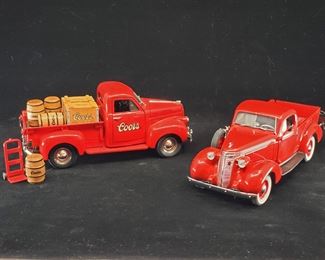 Lot 024-MT: A Die-cast Studebaker Pair

Features:
•	ERTL Diecast Coors 1947 Studebaker M5 Coupe Express Pickup with 4 Coors Barrels and a Handtruck, 3558ZD
•	Danbury Mint Diecast 1937 Studebaker Pickup
