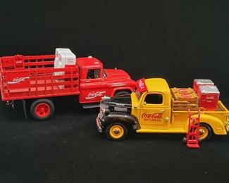 Lot 044-MT: Coca-Cola Die-cast Duo #4

Features:
•	Diecast 1957 Chevrolet 8400 Coke Brand Stake Truck with 2 Vending Machines and Handtruck, no. 1616G
•	Diecast Dodge Coca Cola Bottling Co. Delivery Truck Bank with 2 Vending Machines and Handtruck,no. 2919U


