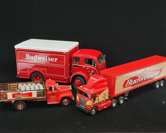Lot 047-MT: Budweiser Die-cast Delivery Truck Trio #2 

Features:
•	Mattel Matchbox Ultra Diecast Budweiser Freightliner C.O.E., no. KS201/A
•	Danbury Mint Diecast 1955 White 3000 Budweiser Delivery Truck with Cases
•	Mattel Matchbox Diecast 1956 Mack B Budweiser Stake Bed Truck with Barrels, Cases and a Handtruck, no 92024


