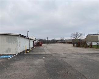 Continue forward to the left you will see the warehouse. Make a left at the corner. 