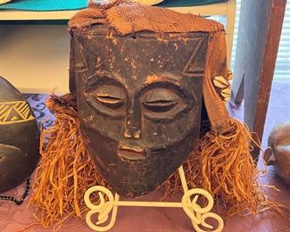 Vintage African mask with shells and grass