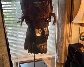 Superb Wobe style African mask with feathered headdress in display case.