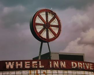 Image of Neon Wheel on original building in Sedalia, Mo