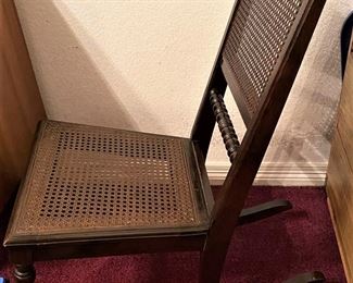 ANTIQUE CHILDS ROCKING CHAIR WITH CANE BOTTOM.