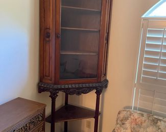 Unique pair of raised corner curio cabinets