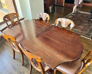 #103) $650 - Solid wood dining table with 8 chairs. Like New. Purchased from McFarland Furniture. $3000 new price. Table brand is Fremarc.  Chairs brand is Artistica.  40Wx78Wx30H. 96Wx40Wx30H with leaves.  Available for pick up near the Country Club Plaza in KCMO