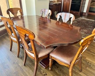 #103) $650 - Solid wood dining table with 8 chairs. Like New. Purchased from McFarland Furniture. $3000 new price. Table brand is Fremarc.  Chairs brand is Artistica.  40Wx78Wx30H. 96Wx40Wx30H with leaves.  Available for pick up near the Country Club Plaza in KCMO
