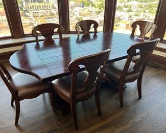 #103) $650 - Solid wood dining table with 8 chairs. Like New. Purchased from McFarland Furniture. $3000 new price. Table brand is Fremarc.  Chairs brand is Artistica.  40Wx78Wx30H. 96Wx40Wx30H with leaves.  Available for pick up near the Country Club Plaza in KCMO
