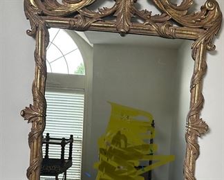 #27) - $150 - Composite Ornately Carved Wall Mirror.  Gold Painted Distressed.  Nieman Marcus.  52 x 34,