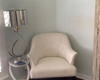 Nice white occasional chair with nailhead trim by Uttermost along with a modern side table and lamp 