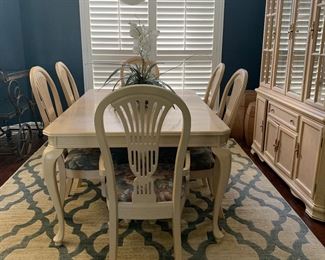 Another view of the dining room with blue and beige geometric rug 