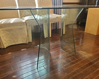 Beautiful thick glass table, 3.5' x 5'.  With 2-curved glass legs.  Three-piece, easy to move to your lovely home.  One edge is beveled.