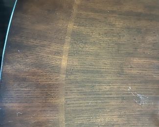 Enlarged look of the top of the dining room tables inlaid wood. This table is 10 foot long and has 8 chairs