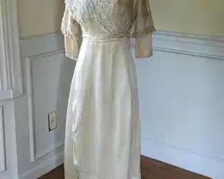 10.)  ca 1900's Bridal/Wedding/ Evening  Dress (?) bobbin tape lace, beads, faux pearls.  Overall condition of gown is excellent except for 1 tiny repair in front  bottom of skirt.  Belt needs a hook and eye to fasten, Minor damage on sheer neckline, and slightly dirty in back.  Beading missing on edge of 1 sleeve.   Measures:  shoulder to shoulder - 14"  Bust - 28"',  Waist -22",  Length - 53"   $425.00