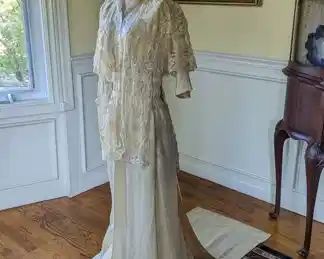 11.)  ca 1910's Bridal/Wedding/Evening dress, Princess lace on machine made netting, faux pearls, embroidery.  Front snap closure, Trained edged with faux pearls - a few missing.  Bottom of skirt and train soiled.  Otherwise, excellent condition.   Measures:  shoulder to shoulder -  14", Bust 28",  Waist 22",  Length 54",  Length with Train - 72".    $550.00