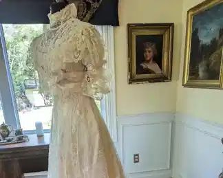 1.)  Antique Brussels Lace Bridal/Wedding gown.  Lace is in excellent condition aside from one small tear in the netting.  Boned bodice, wires in the collar to keep it standing.  Hook and eye closure in back.  Inner silk is shattering.  Some underarm stains - mainly on lining.  Train.  Measures:  shoulder to shoulder - 14", Bust 33", Waist - 27", Length - 57".    $1800.00