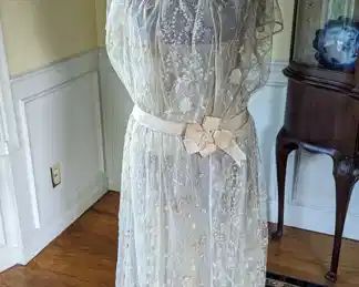 3.)  ca 1920's Embroidered lace bridal/wedding gown.  Satin bows.  Wearable.  Snaps in back.  1 small tear in netting at hem.   Excellent condition.    Measures:  shoulder to shoulder 13", Bust 32", Waist 32", Length 50".  $680.00