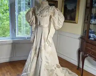 13.)  ca 1895 Bridal/Wedding Gown, Pearls, Lace, Train, Leg-o- Mutton sleeves.  Dress is slightly soiled at edge of train.  A few pearls lost in collar, bodice, and sleeves.  No underarm stains.  Inside stays to keep train pleated.  An occasional light stain.  Dress is in excellent condition.   Measures:  Bodice:  shoulder to shoulder - 12",  Bust - 28",  Waist 20", Length 16".  Skirt:  Waist 18", Length 43",   Length with train - 70".    $650.00