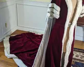16 & 17)  1937  Robe from Coronation of George VI.   Claret velvet lined with Ivory satin.  Robe is 2 pieces and in excellent condition.  There is some minor repair needed to the separation of a couple of seams. There is an area of soiling on the lining  of the train.  1 black spot on the collar of the train is broken.  I will provide the documentation that came with it when it was purchased.  Gorgeous!!   Measures: 34" bust, 24" waist, and 59" from shoulder to front hem (longer in back)  $2200.00