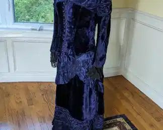 24)  RARE ca 1870's Child's 2 Piece Blue Velvet and Satin dress with lace sleeves.   The description with the dress was it was a childs'.  I believe it is a short adults.  You decide.  Bodice has 1 small hole in back and the lace on the sleeves in delicate with some tears.  Otherwise, in excellent condition.  Skirt has slight age wear on ruffles and waist band.  Slight train.  All appropriate for age.  Skirt is also in excellent condition. Gorgeous!!   Measures:  Bodice:  shoulder to shoulder - 15", Bust - 28",   Waist - 26",  Length - 22".  Skirt:  Waist 22",  Length  - 28".   $675.00
